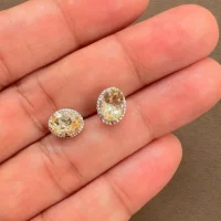 displaying tar studs citrine 5x7mm oval on hand