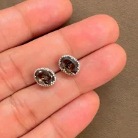 displaying tar studs smoky quartz 5x7mm oval on hand