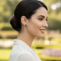 model wearing silver studs triangular shaped with 6mm round Black Onyx and cubic zirconia