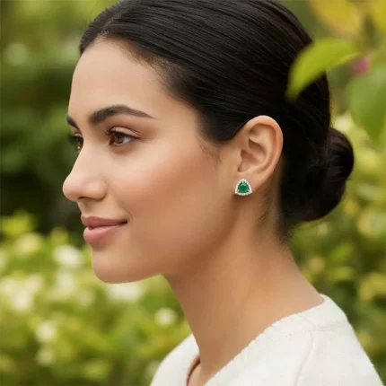 model wearing silver studs triangular shaped with 6mm round Green Onyx and cubic zirconia