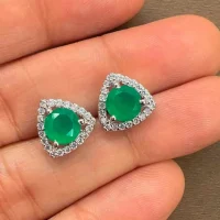 silver studs triangular shaped with 6mm round Green Onyx and cubic zirconia displayed on hand