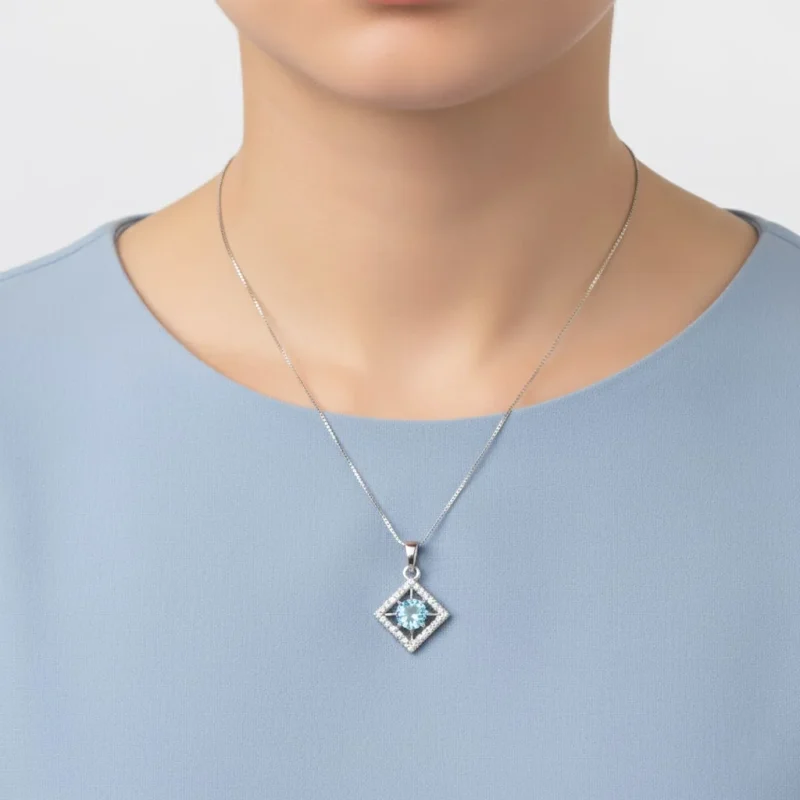 model wearing beautiful square shaped silver pendant with blue topaz and cubic zirconia