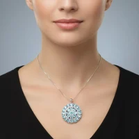 model wearing round shaped blue topaz and cubic zirconia studded silver pendant