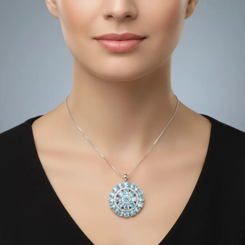model wearing round shaped blue topaz and cubic zirconia studded silver pendant