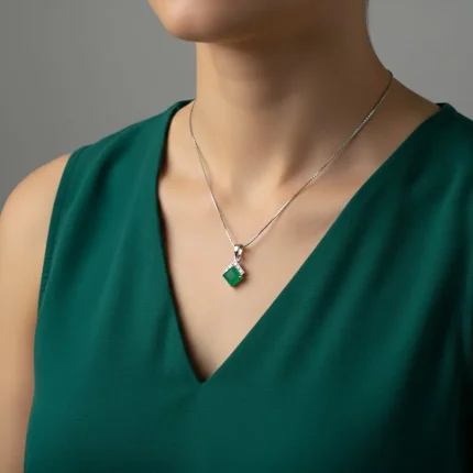 model wearing square shaped green onyx with cubic zirconia silver pendant