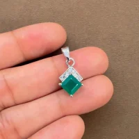square shaped green onyx with cubic zirconia silver pendant displayed on hand