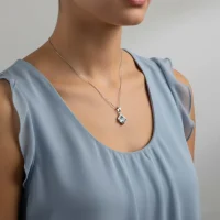 model wearing square shaped blue topaz with cubic zirconia silver pendant