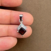 square shaped smoky quartz with cubic zirconia silver pendant displayed on hand