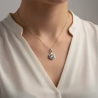 model wearing 5mm round blue topaz with cubic zirconia flower shaped silver pendant