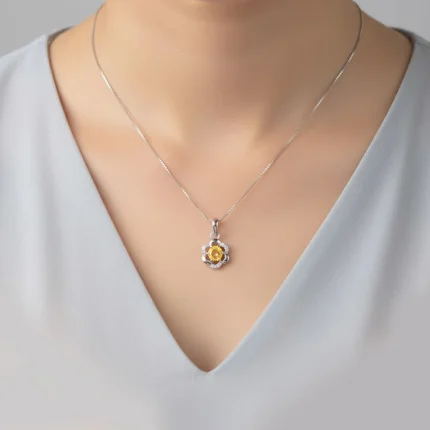 model wearing 5mm round citrine with cubic zirconia flower shaped silver pendant