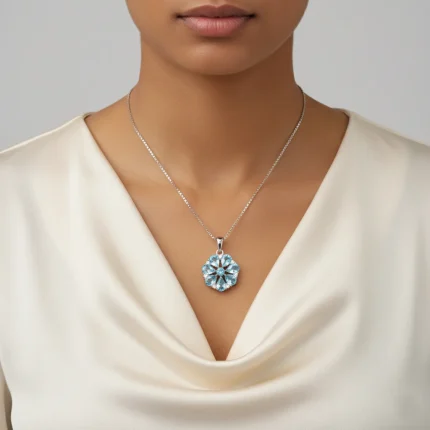 model wearing 5x7 pear shaped blue topaz with cubic zirconia flower shaped silver pendant