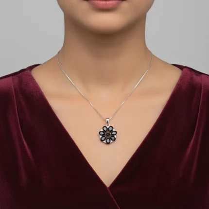 model wearing 5x7 pear shaped black onyx with cubic zirconia flower shaped silver pendant