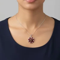model wearing 5x7 pear shaped garnet with cubic zirconia flower shaped silver pendant