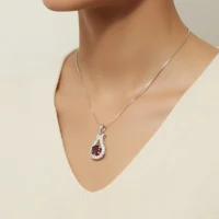 model wearing 6mm round garnet with cubic zirconia silver pendant