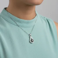 model wearing 6mm round black onyx with cubic zirconia silver pendant