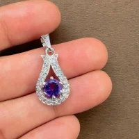 6mm round amethyst with cubic zirconia silver pendant displayed on hand