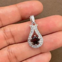 6mm round smoky quartz with cubic zirconia silver pendant displayed on hand
