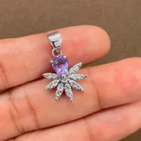 5x7 mm pear shaped brazilian amethyst with cubic zirconia silver flower pendant displayed on hand