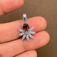 5x7 mm pear shaped smoky quartz with cubic zirconia silver flower pendant displayed on hand