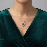 model wearing 5x7 mm pear shaped garnet with cubic zirconia silver heart shaped pendant