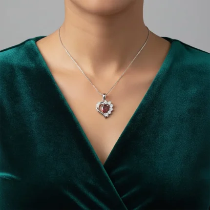 model wearing 5x7 mm pear shaped garnet with cubic zirconia silver heart shaped pendant
