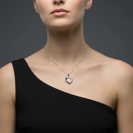 model wearing 5x7 mm pear shaped rainbow moonstone with cubic zirconia silver heart shaped pendant