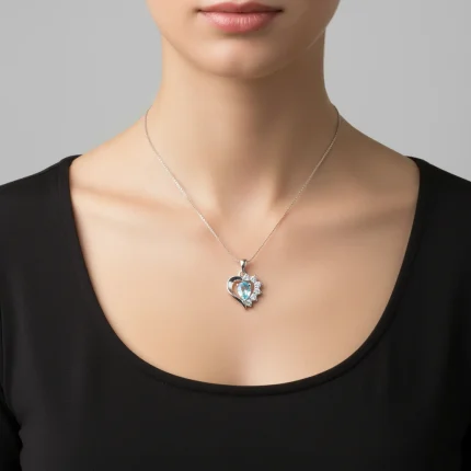model wearing 5x7 mm pear shaped blue topaz with cubic zirconia silver heart shaped pendant