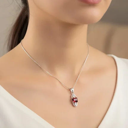 model wearing 5x7mm octagon shaped garnet with cubic zirconia silver pendant
