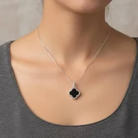 model wearing silver pendant clover shaped black onyx