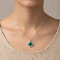model wearing silver pendant clover shaped green onyx