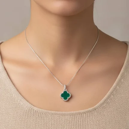 model wearing silver pendant clover shaped green onyx
