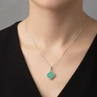 model wearing silver pendant clover shaped malachite