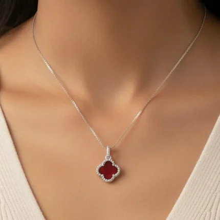 model wearing silver pendant clover shaped red onyx