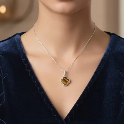 model wearing silver pendant clover shaped tiger's eye