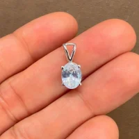 silver pendant single piece 6x8mm oval cubic zirconia displayed on hand