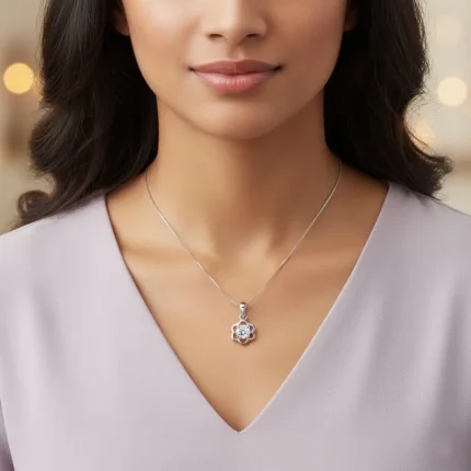 model wearing flower shaped silver pendant with cubic zirconia
