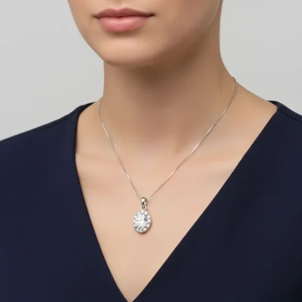 model wearing silver pendant cluster with 7x9 mm oval cubic zirconia