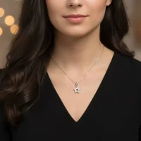 model wearing star shaped hollow silver pendant with cubic zirconia