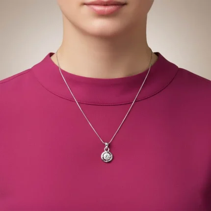 model wearing silver pendant with 6mm round single piece cubic zirconia
