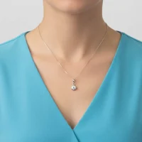 model wearing silver pendant with 5mm cubic zirconia in band setting