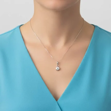 model wearing silver pendant with 5mm cubic zirconia in band setting