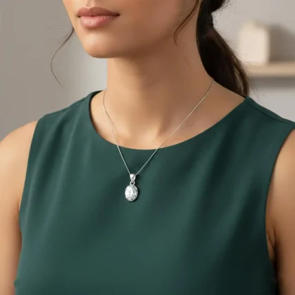 model wearing silver pendant with 7x9mm oval cubic zirconia in tar setting