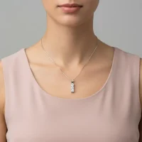 model wearing silver pendant with three piece 4mm round cubic zirconia