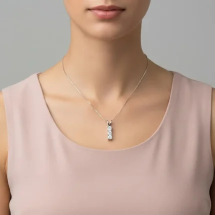 model wearing silver pendant with three piece 4mm round cubic zirconia