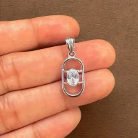 oval shaped 5x7 mm cubic zirconia pendant showing on hand