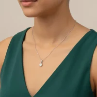 model wearing silver pendant with 4mm cubic zirconia in band setting