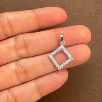 Square shaped hollow silver pendant with cubic zirconia displaying on hand