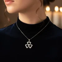 model wearing flower shaped silver pendant with 3.5 mm round cubic zirconia