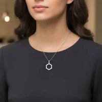 model wearing Hexagon shaped hollow silver pendant with cubic zirconia