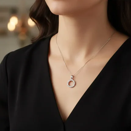 model wearing circle shaped hollow silver pendant with cubic zirconia